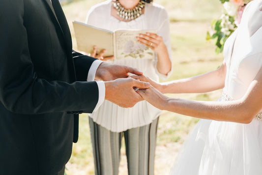 Bride and groom holding hands during their wedding ceremony